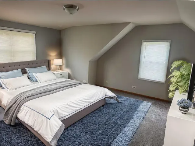 a bedroom with bed and a window