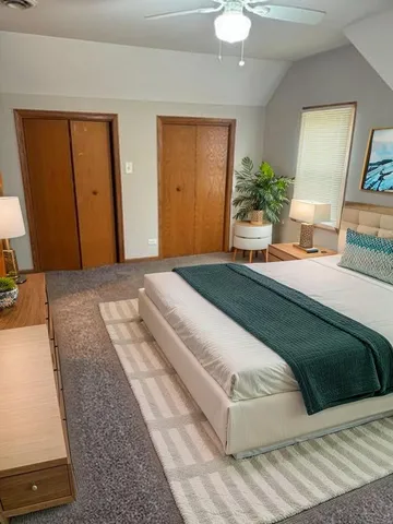 a bedroom with a large bed and potted plant