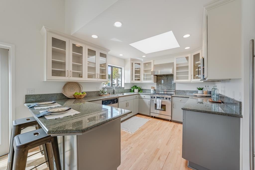 117 El Camino Del Mar Aptos, CA 95003 - Photo 14 of 60 a kitchen with granite countertop lots of counter top space and stainless steel appliances