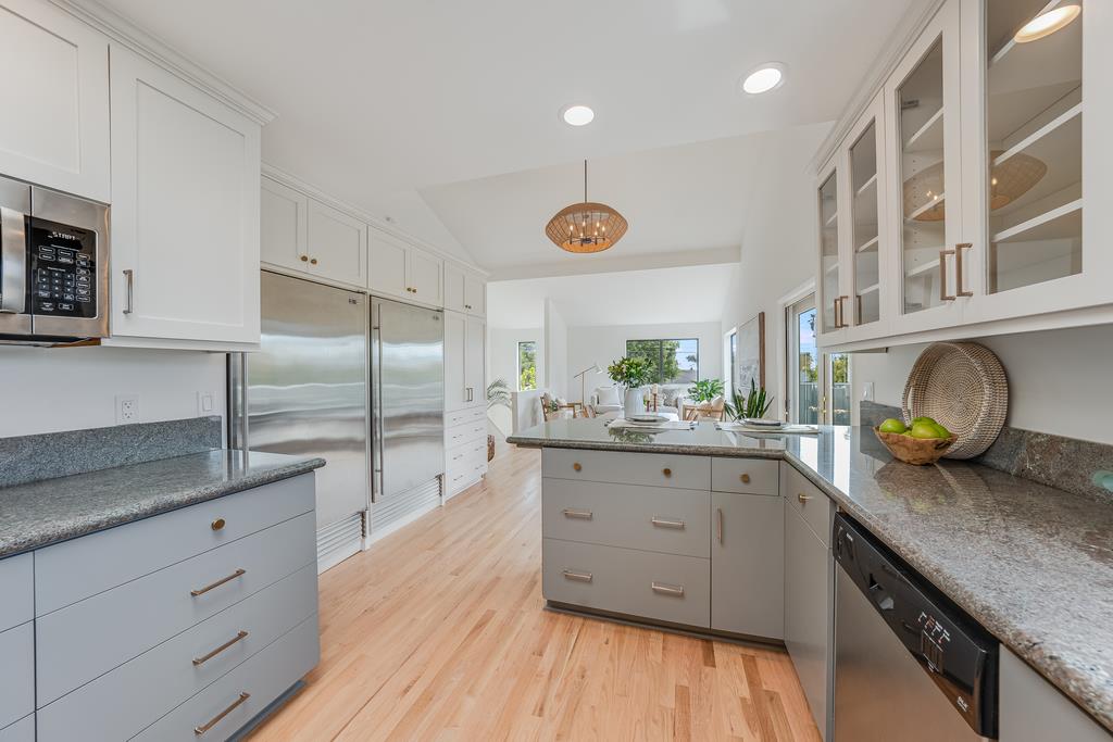 117 El Camino Del Mar Aptos, CA 95003 - Photo 15 of 60 a kitchen with granite countertop a stove a sink and a refrigerator