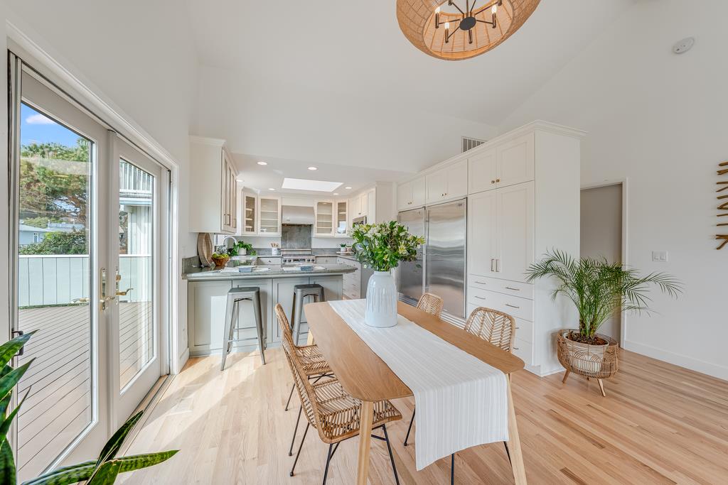 117 El Camino Del Mar Aptos, CA 95003 - Photo 17 of 60 a dining room with furniture potted plants and wooden floor