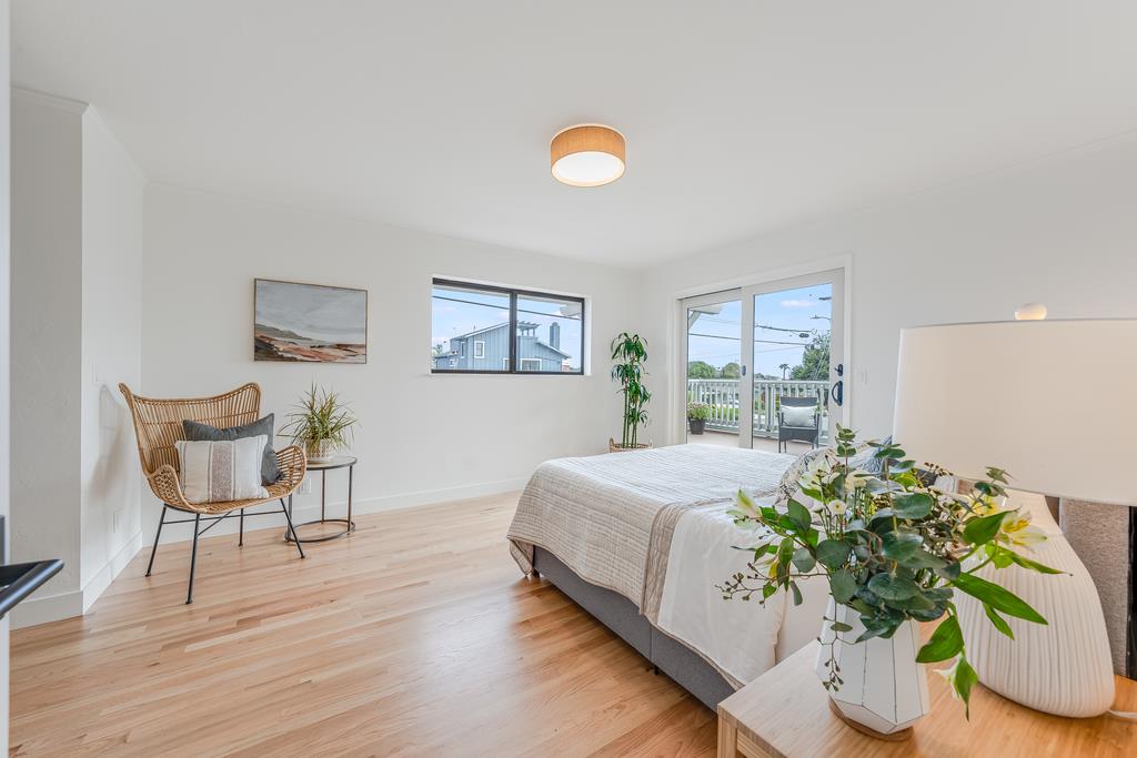 117 El Camino Del Mar Aptos, CA 95003 - Photo 23 of 60 a bedroom with a bed and a painting on the wall