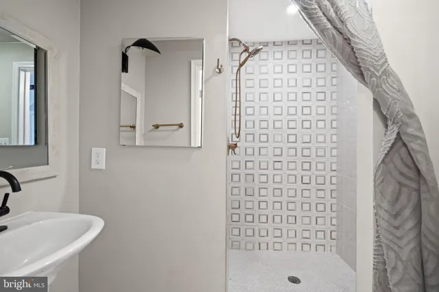 a bathroom with a shower and a sink