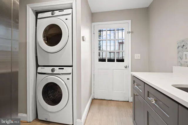 a utility room with sink dryer and washer