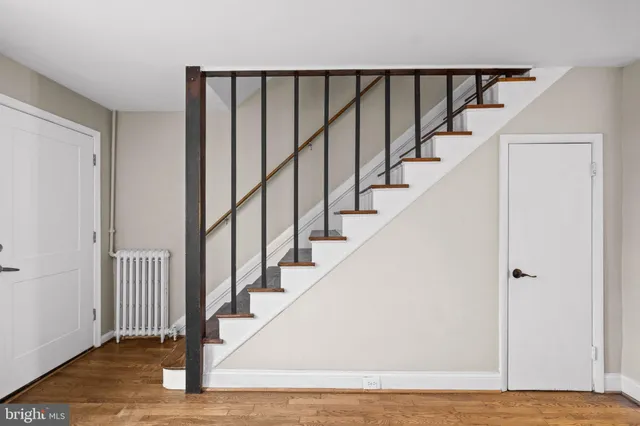 a view of staircase with wooden floor and a window