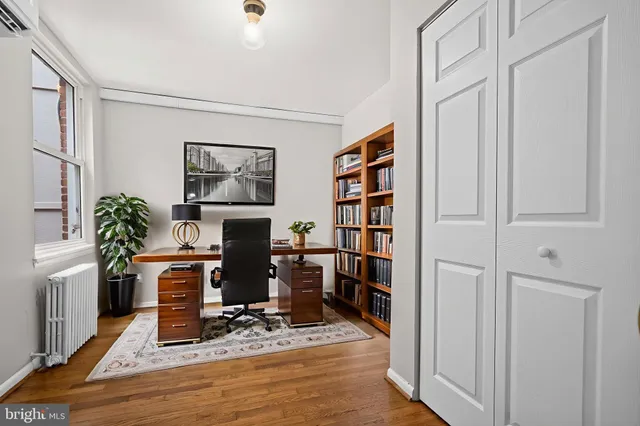 a living room with furniture a bookshelf and a bookshelf