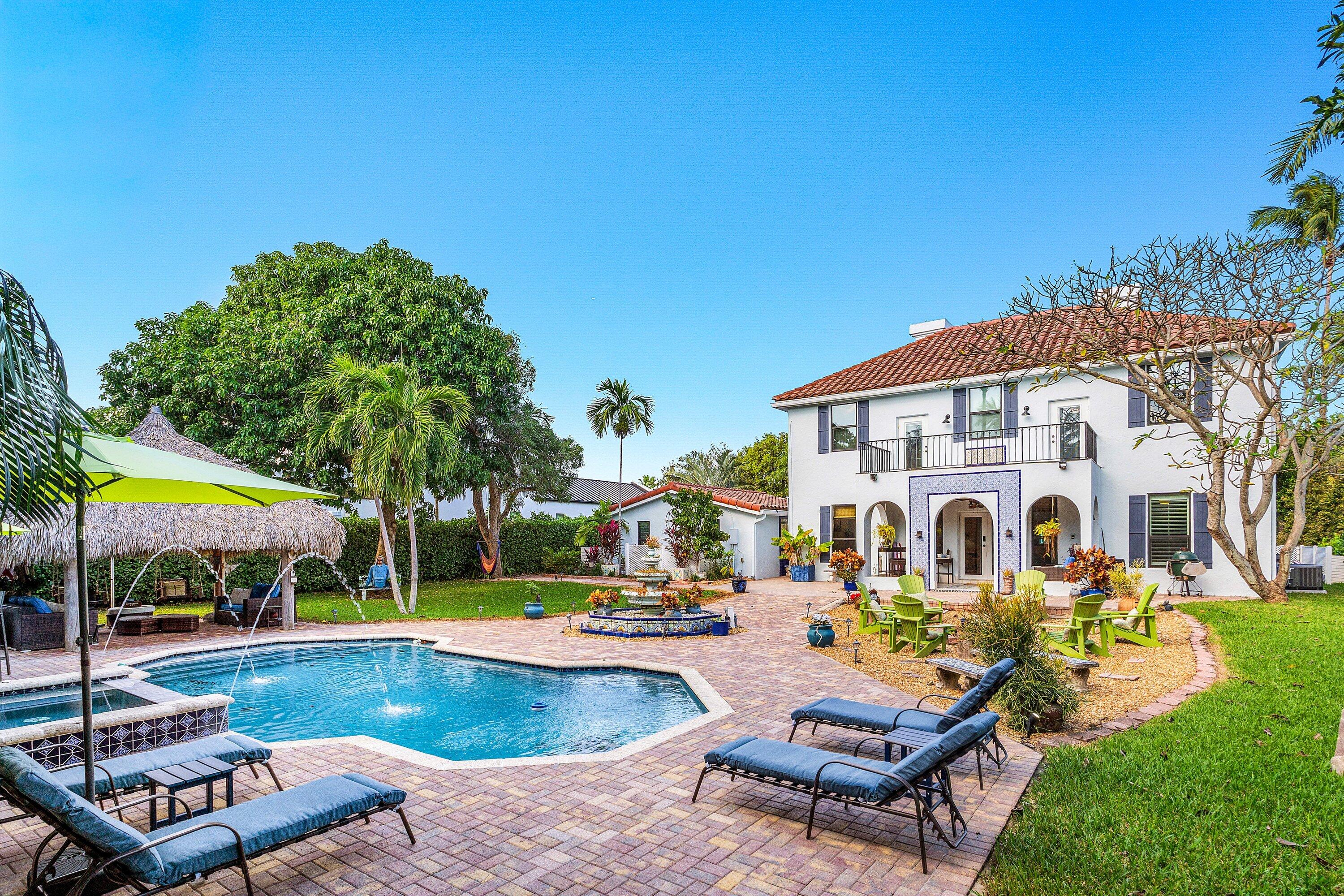 19 East Ocean Avenue Ocean Ridge, FL 33435 - Photo 1 of 24 a view of a swimming pool with lounge chairs