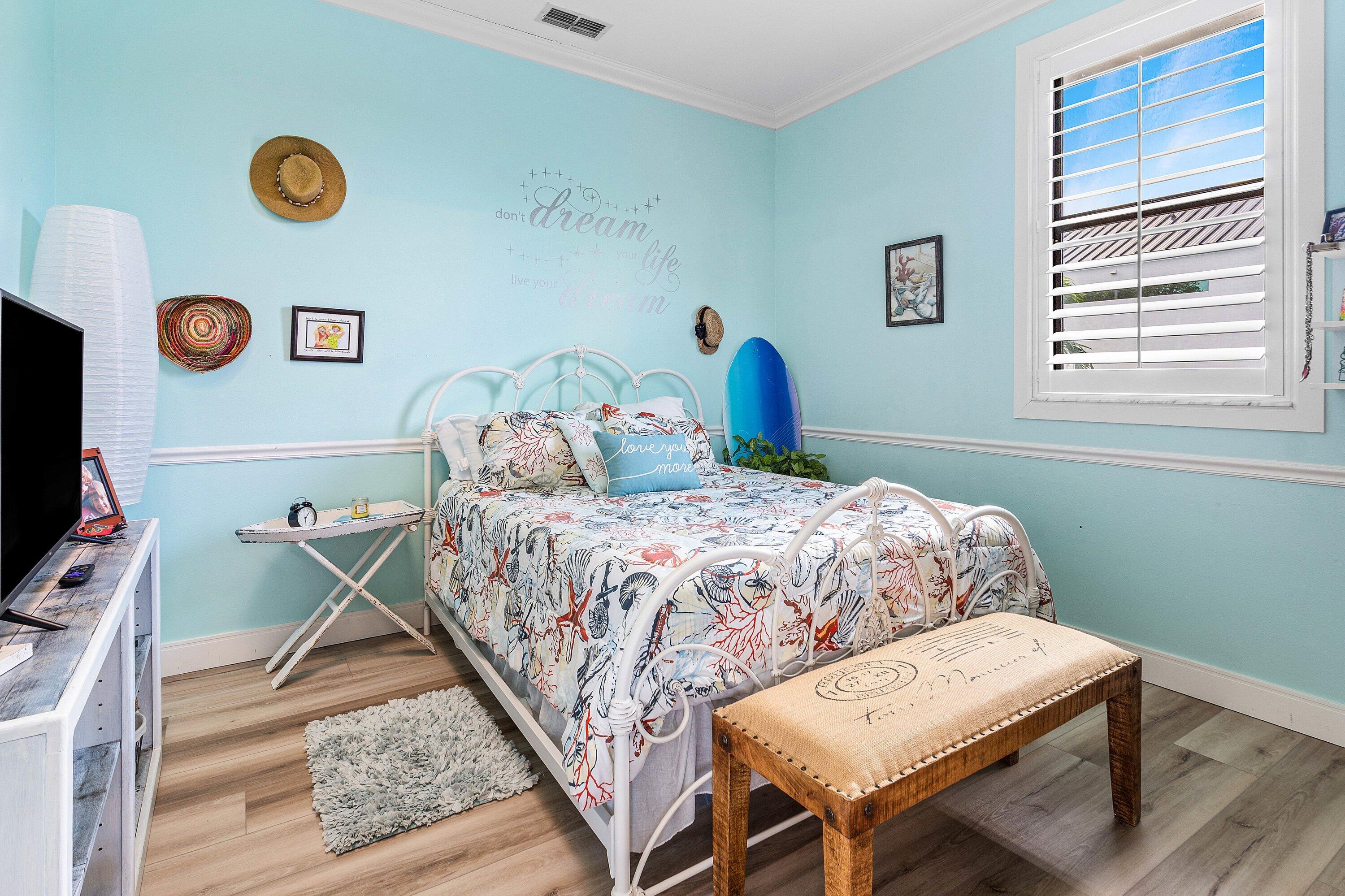 19 East Ocean Avenue Ocean Ridge, FL 33435 - Photo 13 of 24 a bedroom with a bed and a flat screen tv