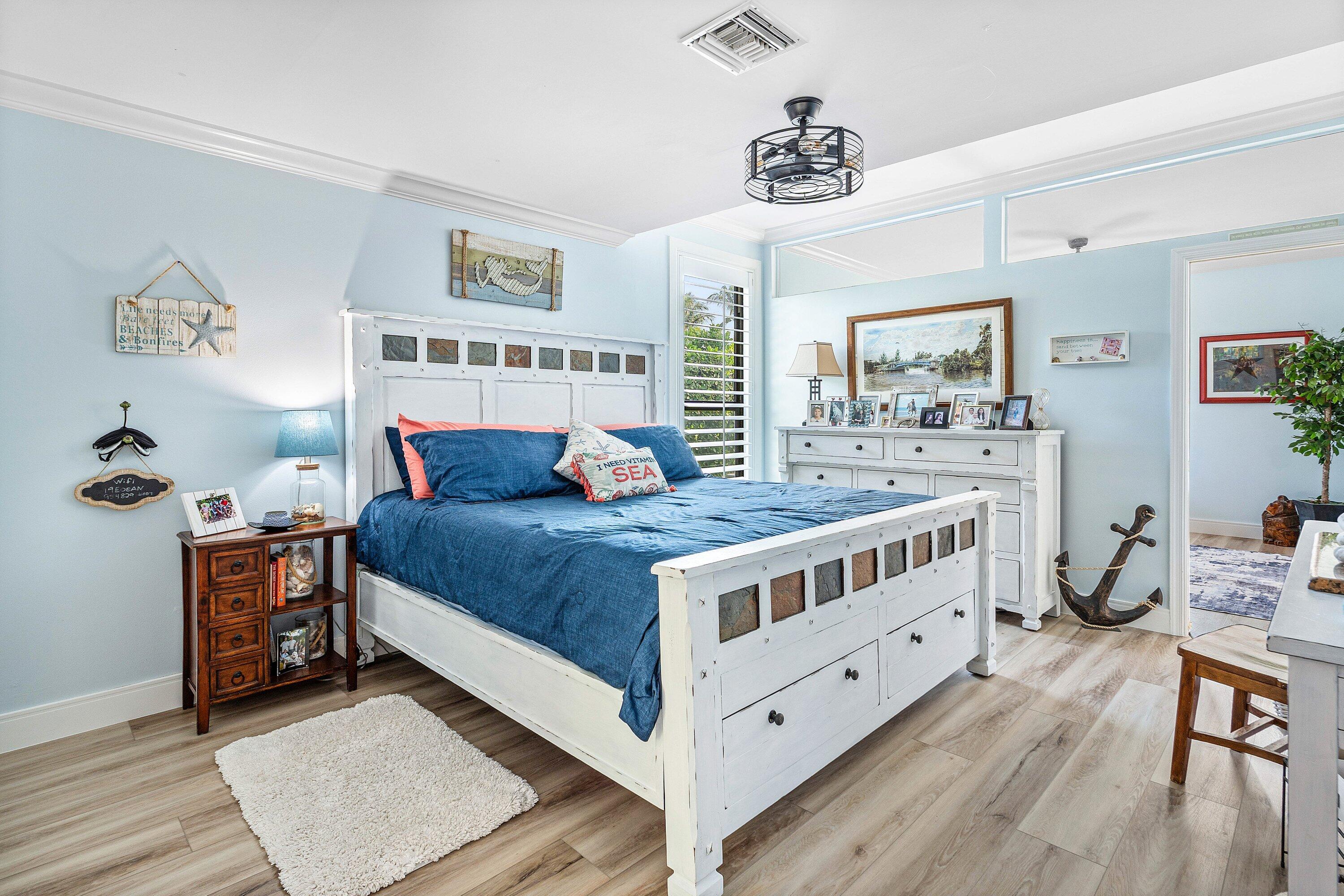 19 East Ocean Avenue Ocean Ridge, FL 33435 - Photo 15 of 24 a large bedroom with a bed and a table in it