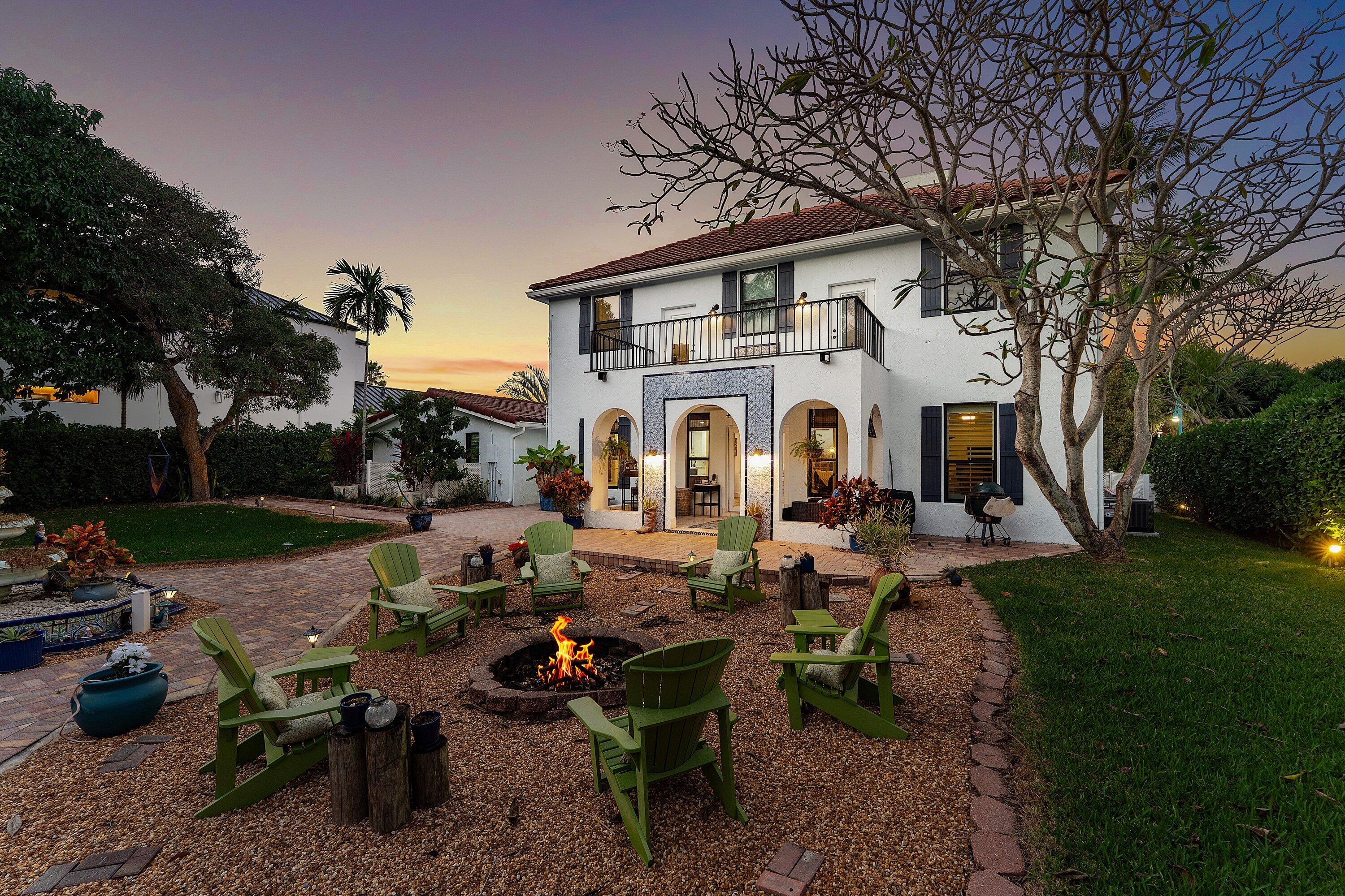 19 East Ocean Avenue Ocean Ridge, FL 33435 - Photo 23 of 24 a view of a white house with a chairs in patio