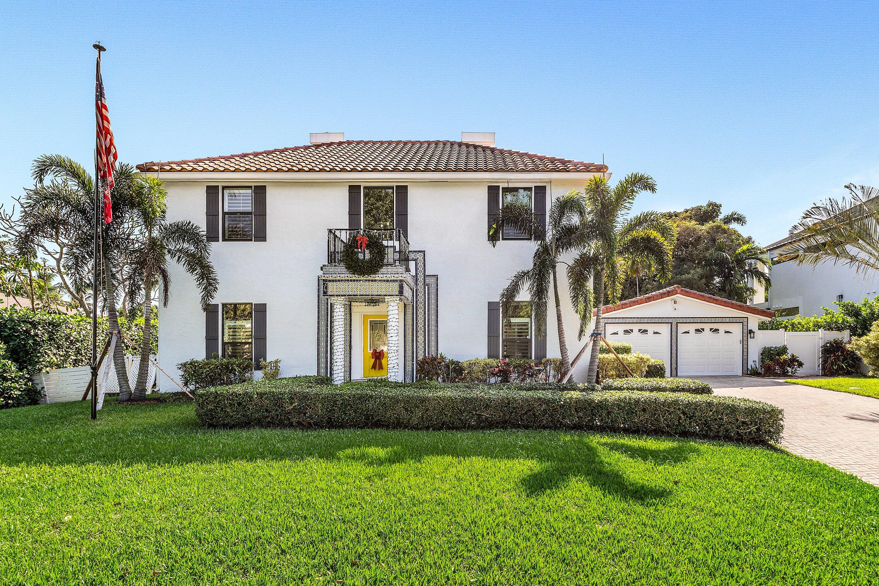19 East Ocean Avenue Ocean Ridge, FL 33435 - Photo 3 of 24 a front view of house with yard and green space