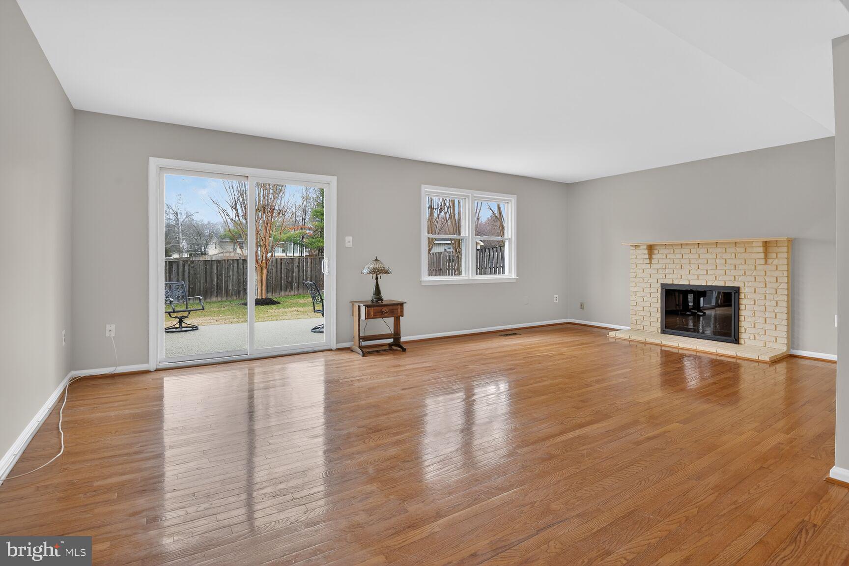7140 Hamor Lane Springfield, VA 22153 - Photo 13 of 29 a view of empty room with wooden floor and fireplace