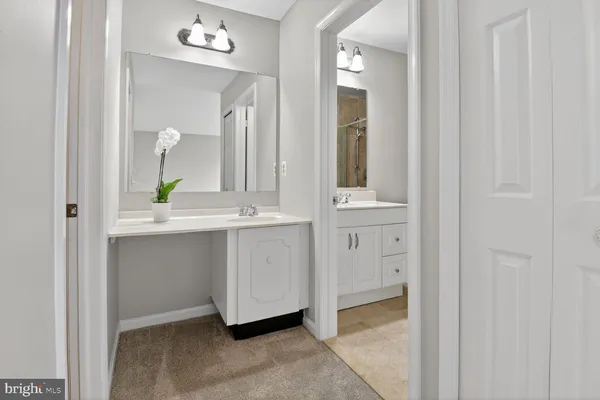a bathroom with a vanity and a mirror