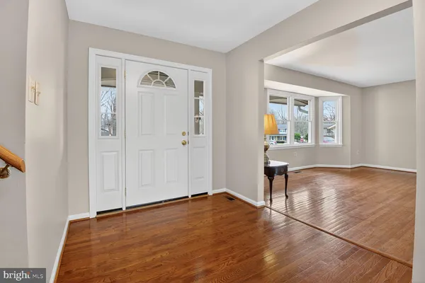 an empty room with window and wooden floor