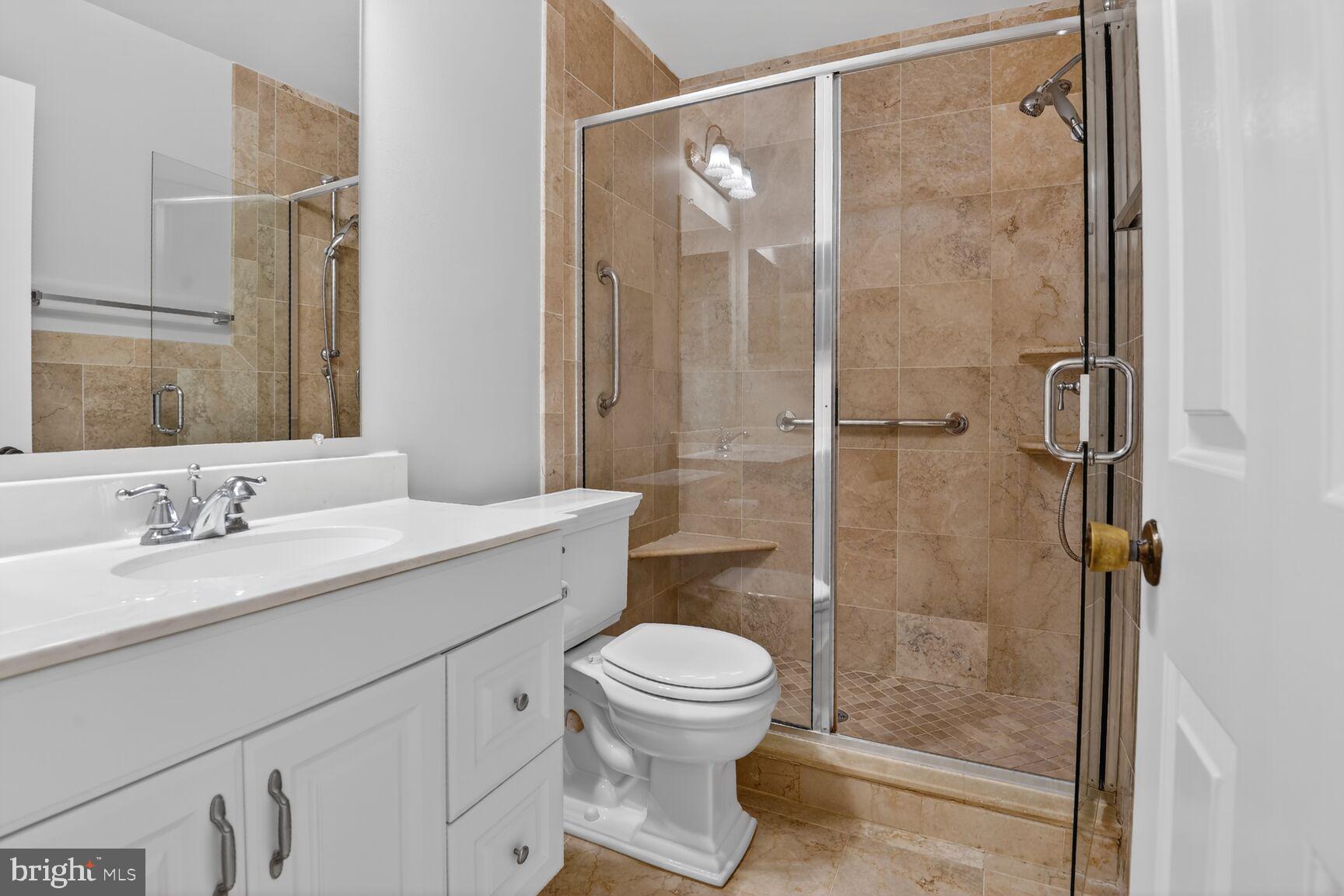 7140 Hamor Lane Springfield, VA 22153 - Photo 23 of 29 a bathroom with a sink a toilet and shower