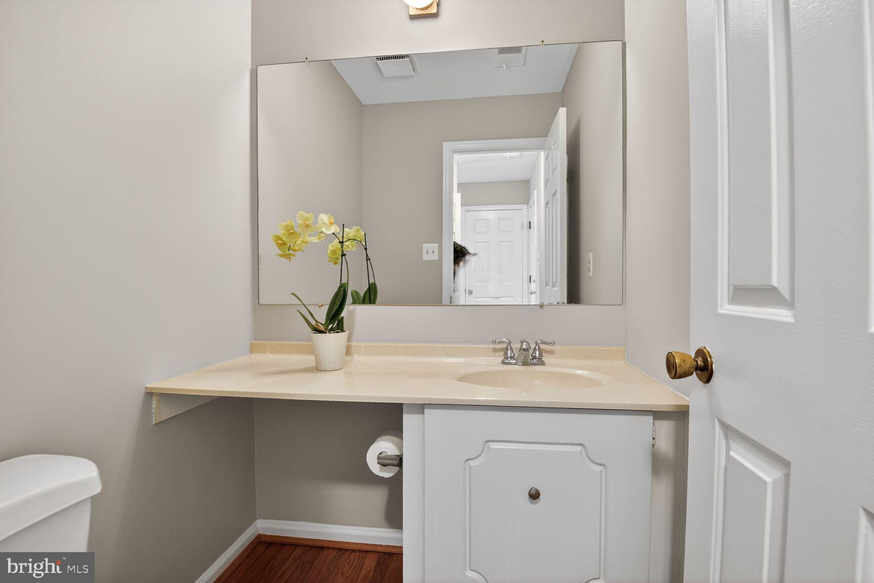 7140 Hamor Lane Springfield, VA 22153 - Photo 25 of 29 a bathroom with a toilet sink and mirror