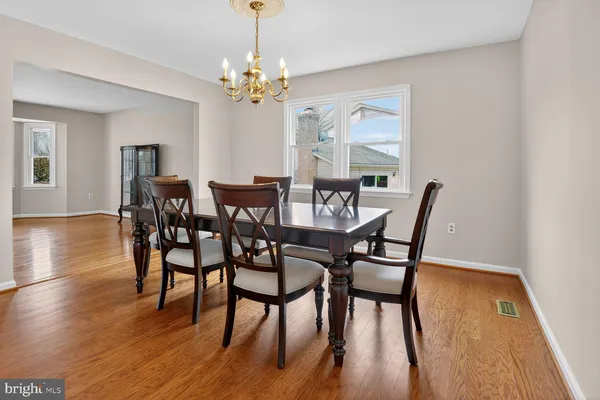 a view of a dining room with furniture wooden floor and chandelier