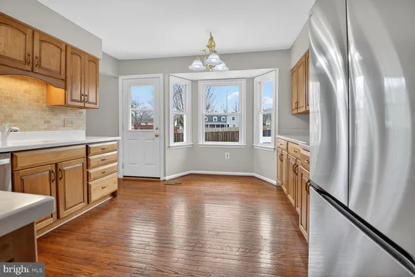 a view of a big room with wooden floor and windows