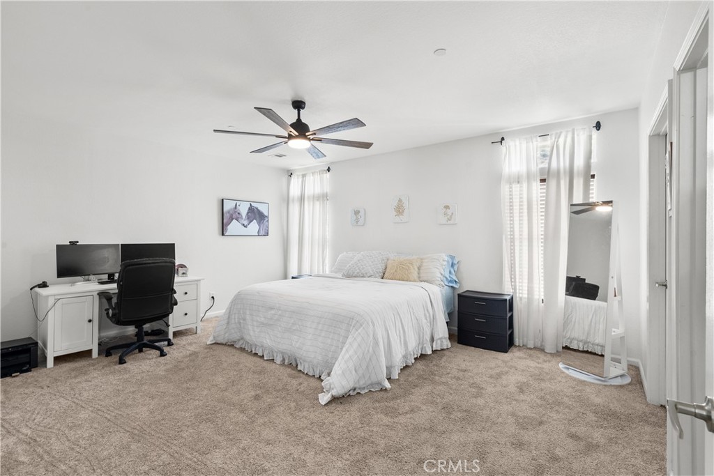 31053 Hasley Canyon Road Castaic, CA 91384 - Photo 15 of 50 a spacious bedroom with a bed and a chandelier