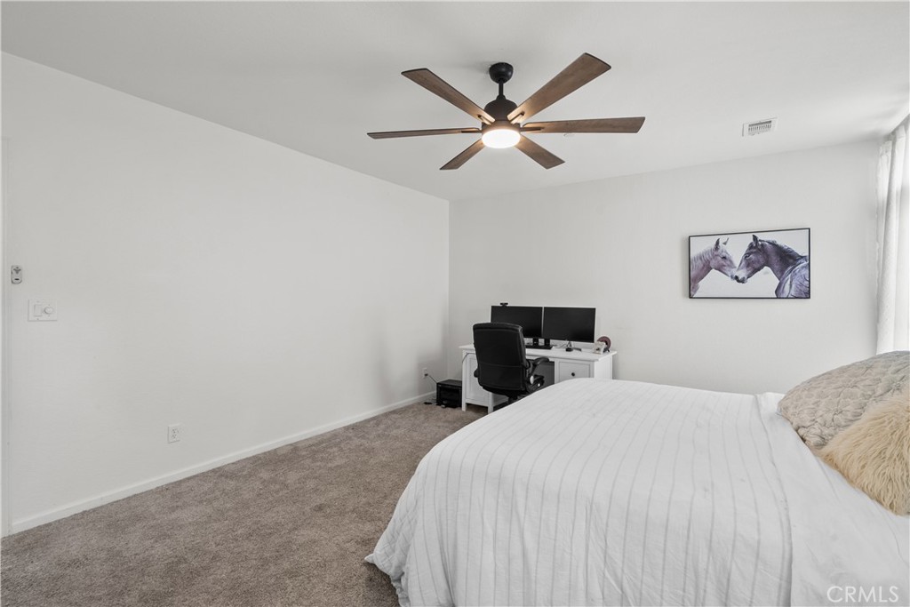 31053 Hasley Canyon Road Castaic, CA 91384 - Photo 16 of 50 a bedroom with a bed and a chandelier