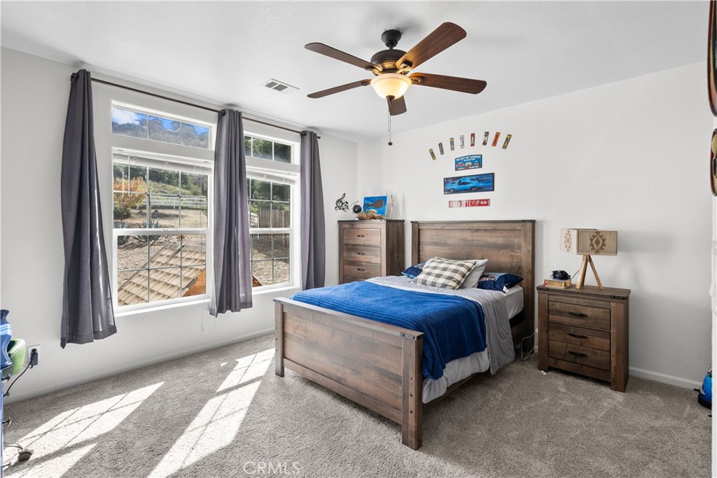31053 Hasley Canyon Road Castaic, CA 91384 - Photo 23 of 50 a bedroom with a bed dresser and a window