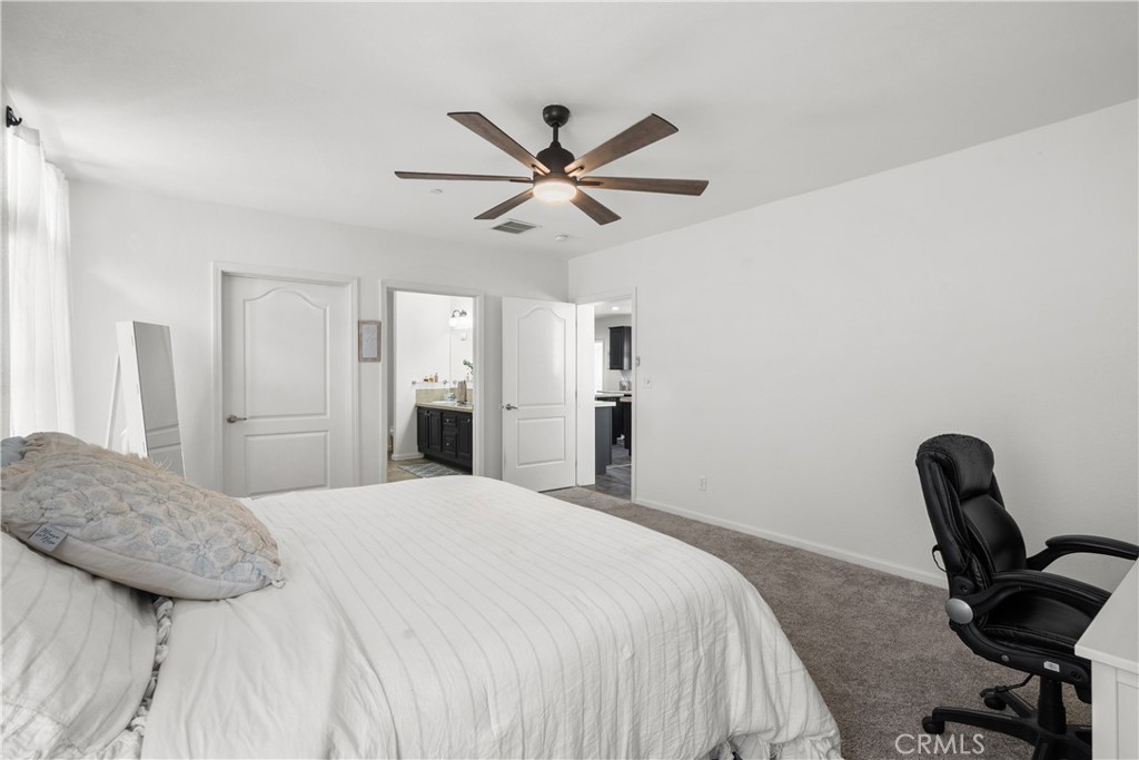 31053 Hasley Canyon Road Castaic, CA 91384 - Photo 29 of 50 a bedroom with a bed a desk and chair