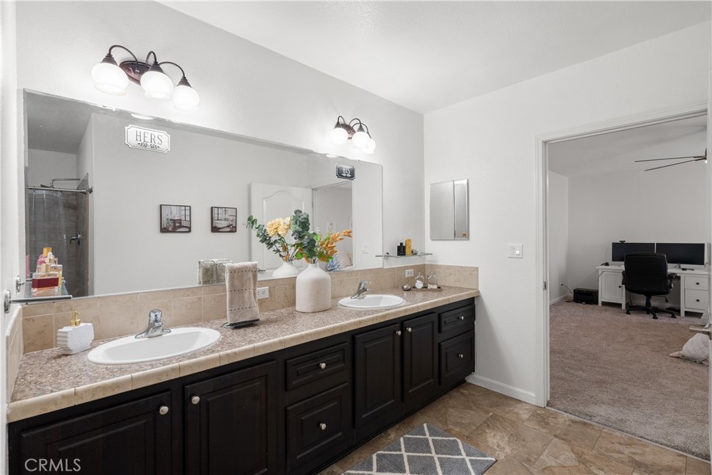 31053 Hasley Canyon Road Castaic, CA 91384 - Photo 30 of 50 a spacious bathroom with a granite countertop double sink and mirror