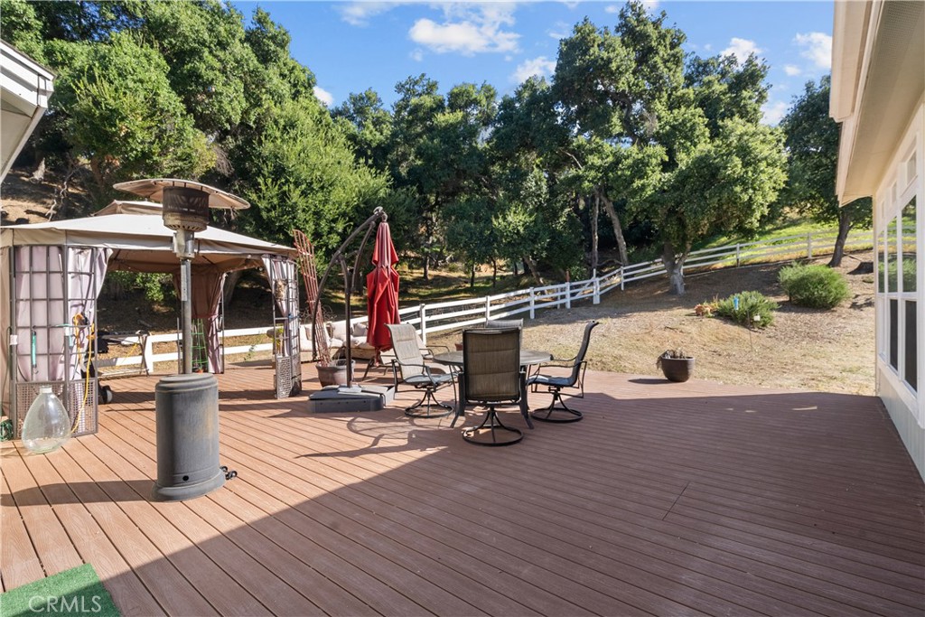 31053 Hasley Canyon Road Castaic, CA 91384 - Photo 32 of 50 a view of a patio with table and chairs and wooden floor