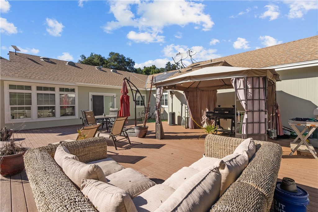 31053 Hasley Canyon Road Castaic, CA 91384 - Photo 36 of 50 a view of a patio with couches table and chairs and potted plants