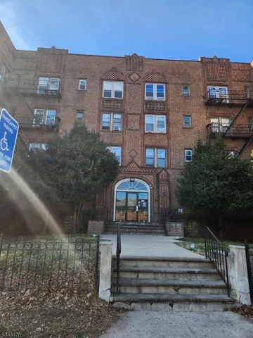 a view of a brick house with a yard