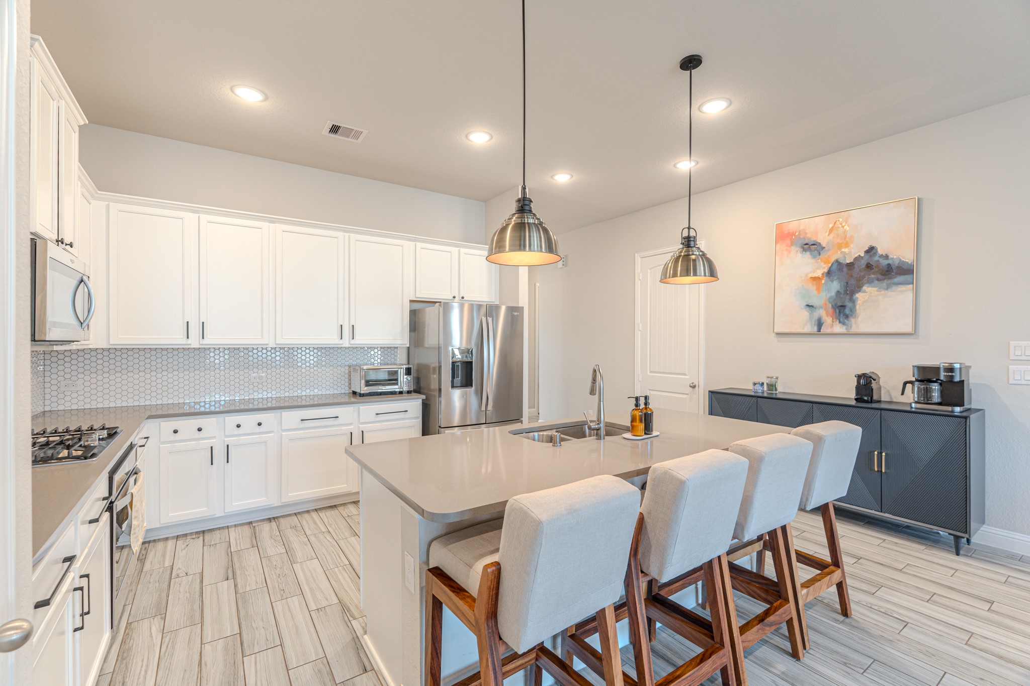 17310 Autumn Sage Court Conroe, TX 77385 - Photo 11 of 31 a kitchen with stainless steel appliances granite countertop a kitchen island a stove and a sink