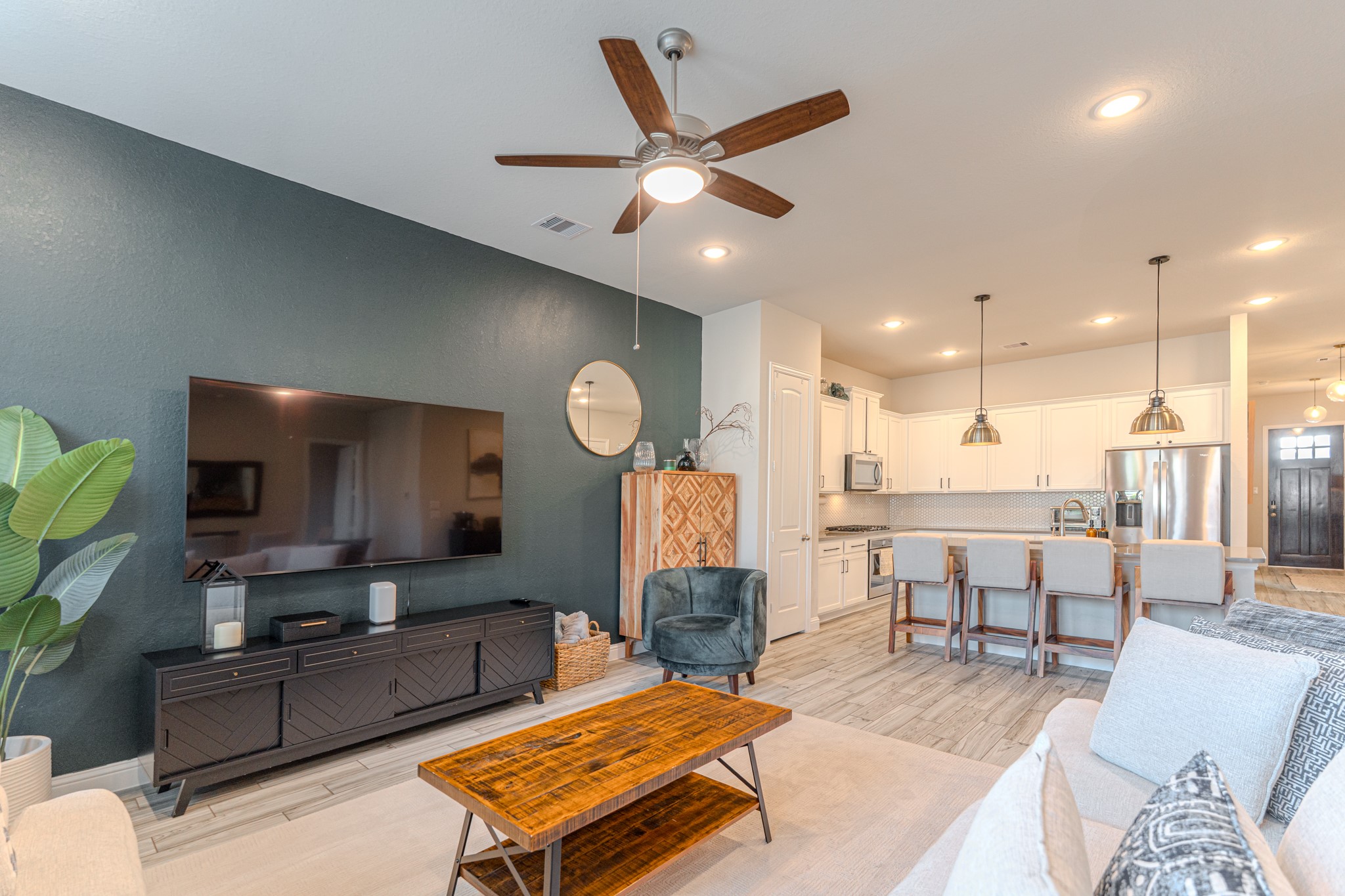 17310 Autumn Sage Court Conroe, TX 77385 - Photo 16 of 31 a living room with furniture kitchen view and a wooden floor