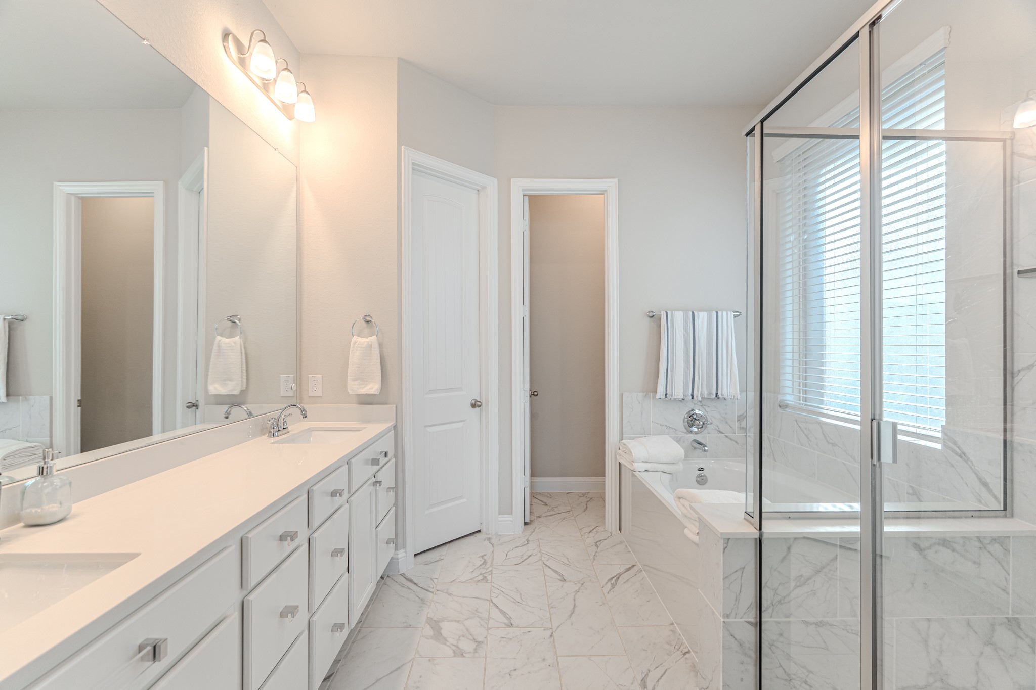 17310 Autumn Sage Court Conroe, TX 77385 - Photo 20 of 31 a spacious bathroom with a double vanity sink mirror and double