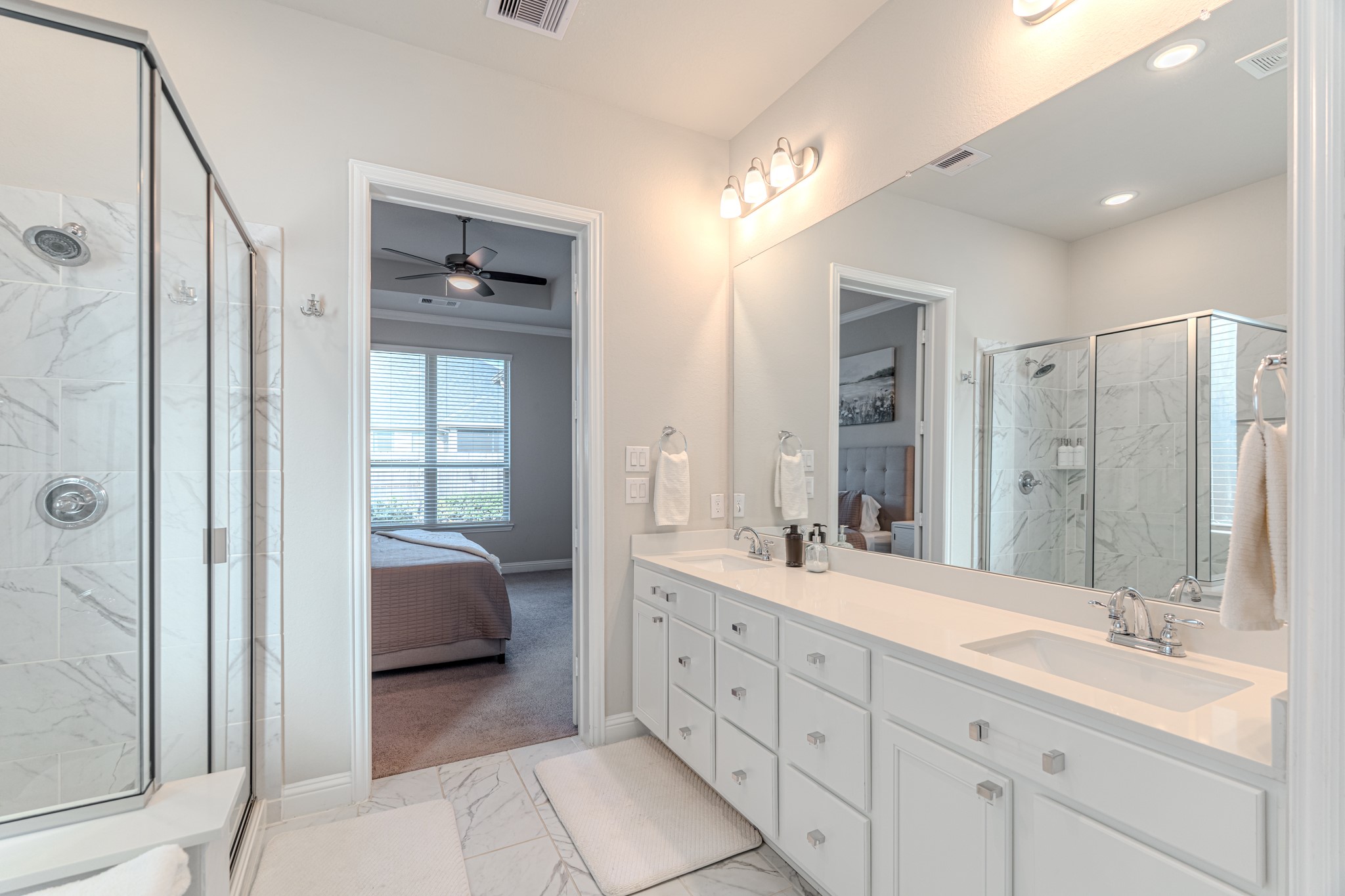 17310 Autumn Sage Court Conroe, TX 77385 - Photo 22 of 31 a spacious bathroom with a double vanity sink a mirror and a shower