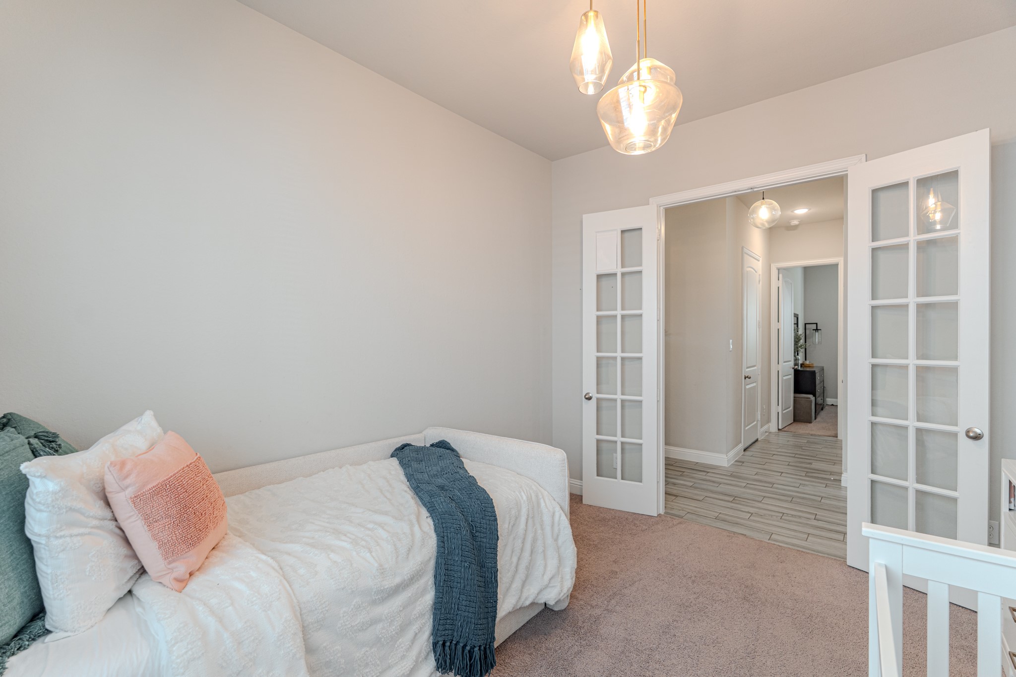 17310 Autumn Sage Court Conroe, TX 77385 - Photo 24 of 31 a spacious bedroom with a bed and a chandelier