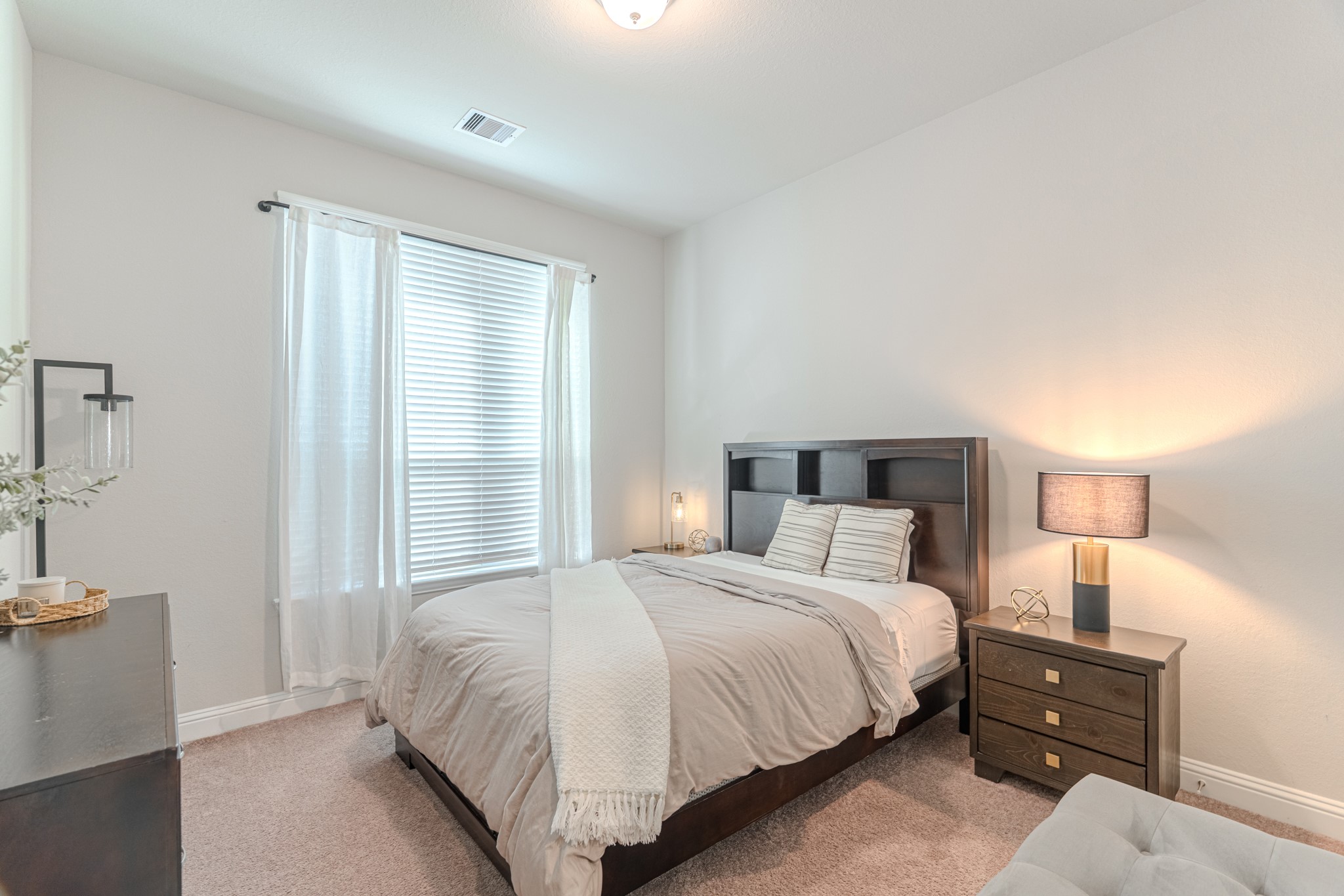 17310 Autumn Sage Court Conroe, TX 77385 - Photo 25 of 31 a bedroom with a bed and a night stand