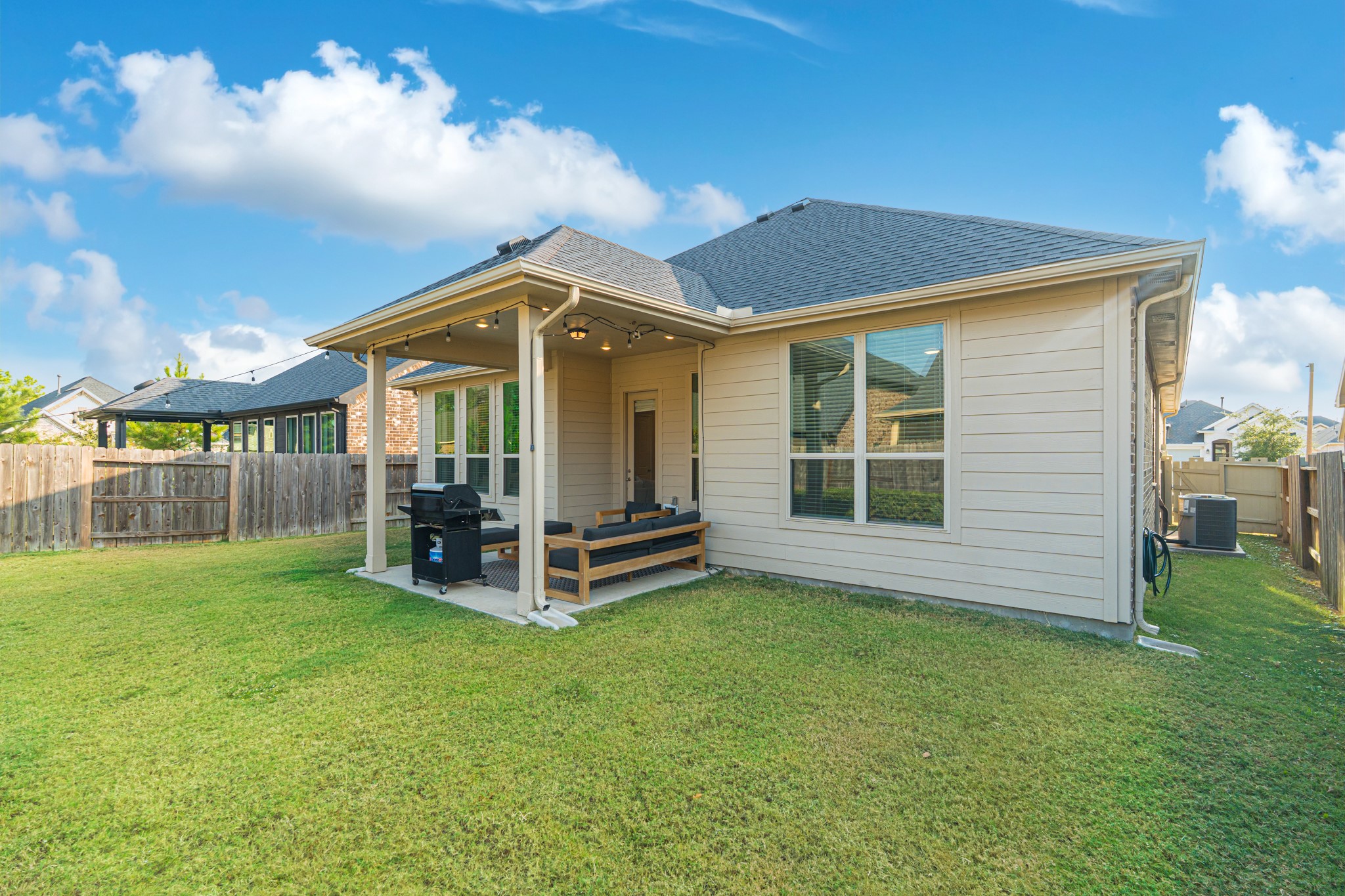 17310 Autumn Sage Court Conroe, TX 77385 - Photo 29 of 31 a view of a chair and table in backyard of the house
