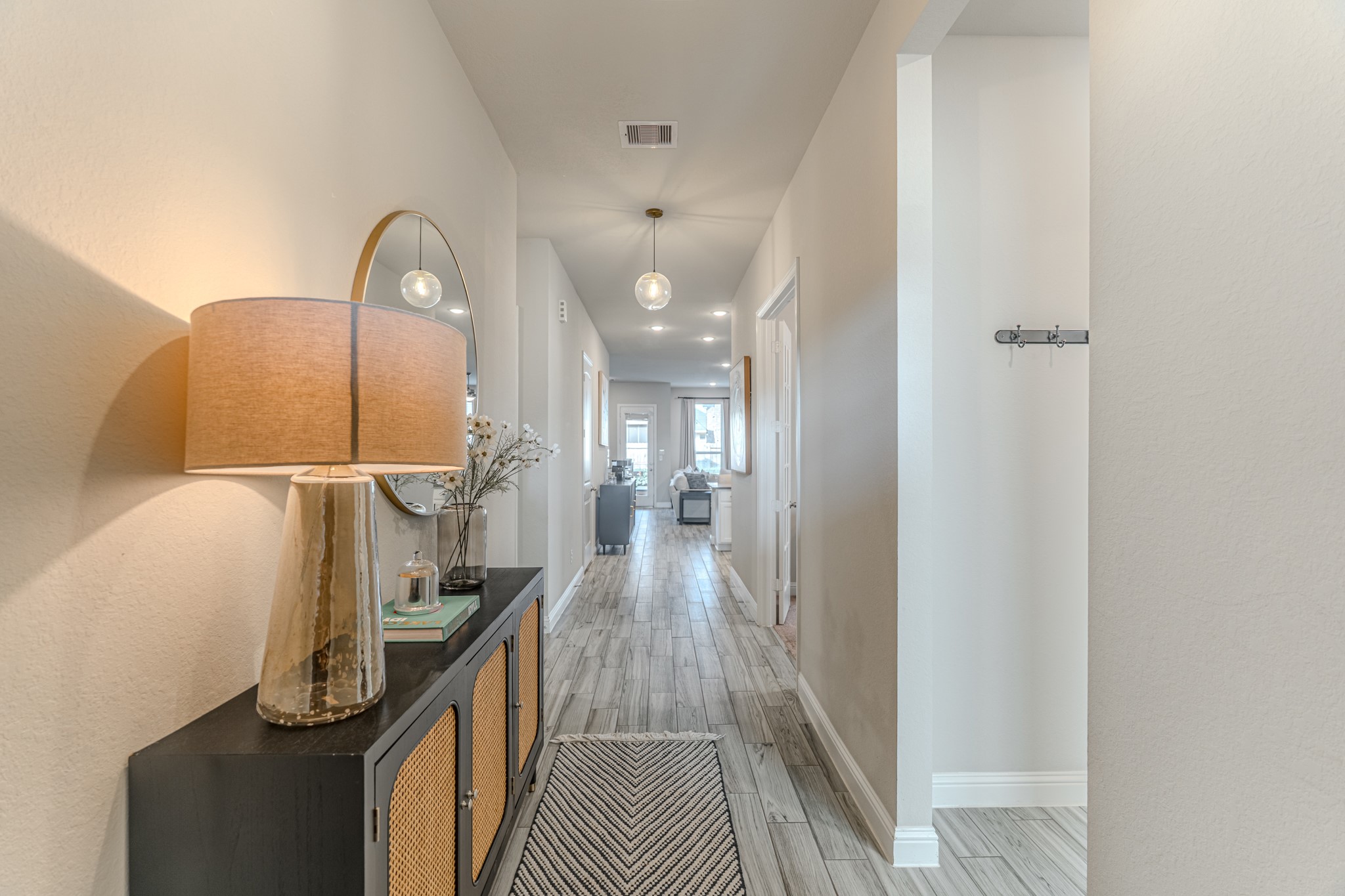 17310 Autumn Sage Court Conroe, TX 77385 - Photo 7 of 31 a view of a hallway with wooden floor