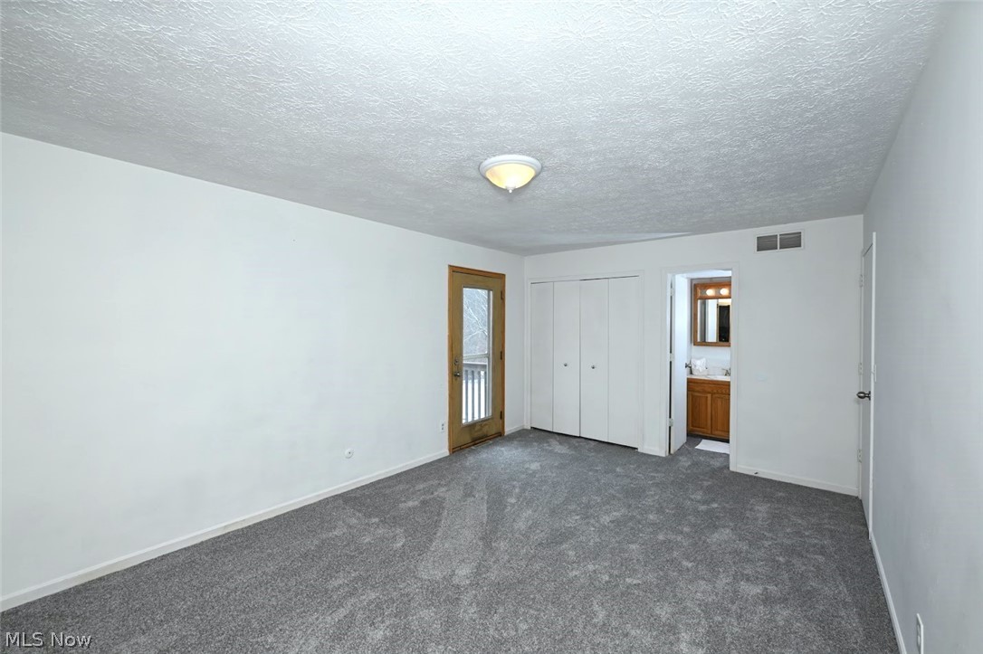 6151 Taylor Road Clinton, OH 44216 - Photo 31 of 49 *MASTER BDRM, HERE IS THE 2ND CLOSET AND ENSUITE HALF BATHROOM, ALSO DOORWAY TO THE BALCONY ~