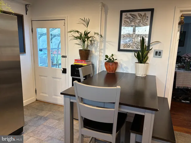 a view of a dining room with furniture and a potted plant