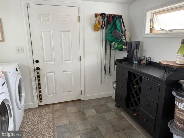 a view of a kitchen with a sink and a washer dryer
