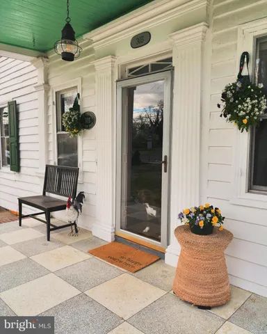 a front view of a house with a potted plant