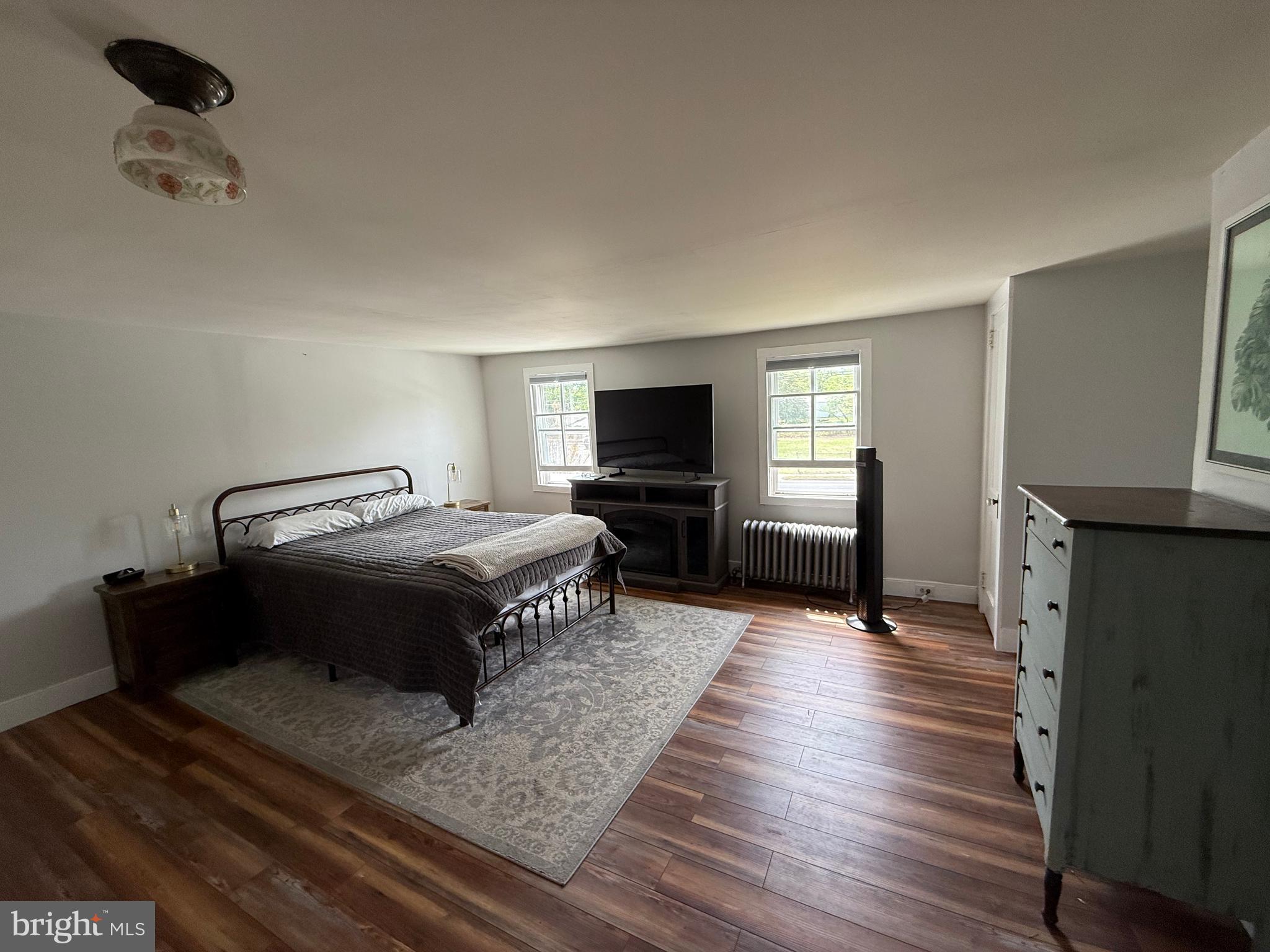 303 Baptist Road Newport, NJ 08345 - Photo 23 of 42 a spacious bedroom with a bed and wooden floor