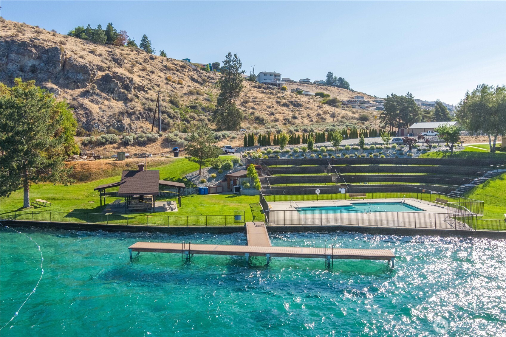 122 Lookout Way Chelan, WA 98816 - Photo 37 of 40 a view of a swimming pool with a yard and plants