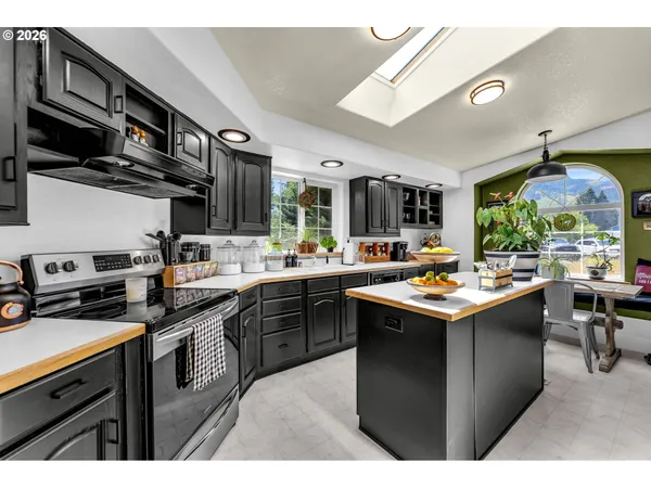 a kitchen with stainless steel appliances a sink stove and cabinets