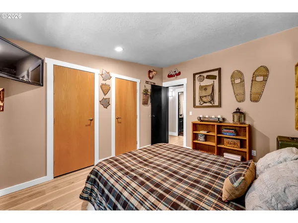 a bedroom with a bed and cupboard