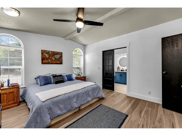 a bedroom with a large bed and a chandelier