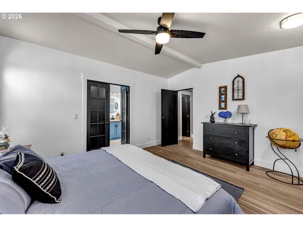 a bedroom with a bed and a chandelier