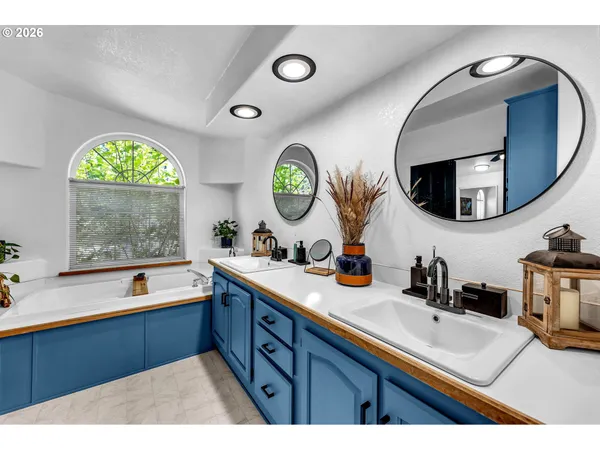 a bathroom with a double vanity sink and a mirror
