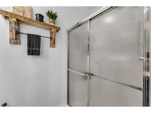 a bathroom with a shower and a mirror